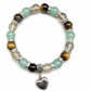 Pulsera de Ojo de Tigre Natural con Colgante de Corazón: Estilo y Calidez